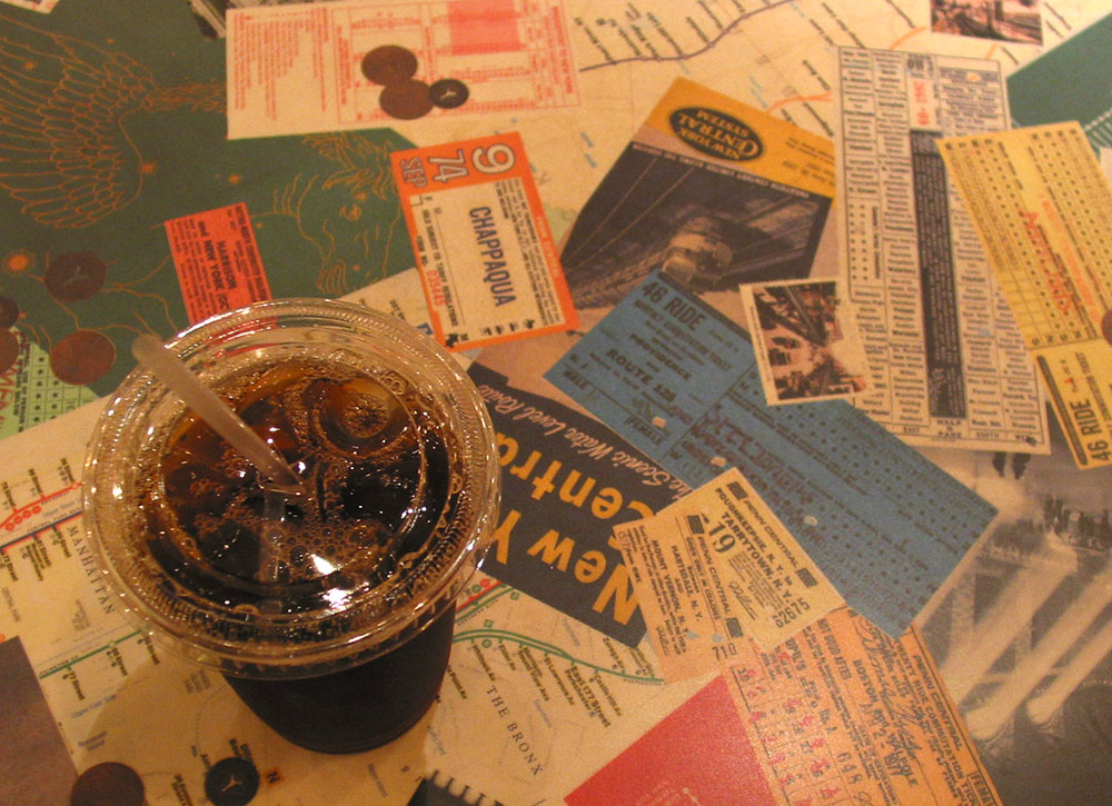 A cup of iced coffee on a table in Grand Central Station.
