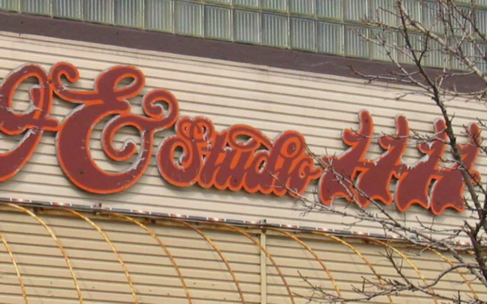 Sign on a building that reads ‘Ampersand Studio 111’