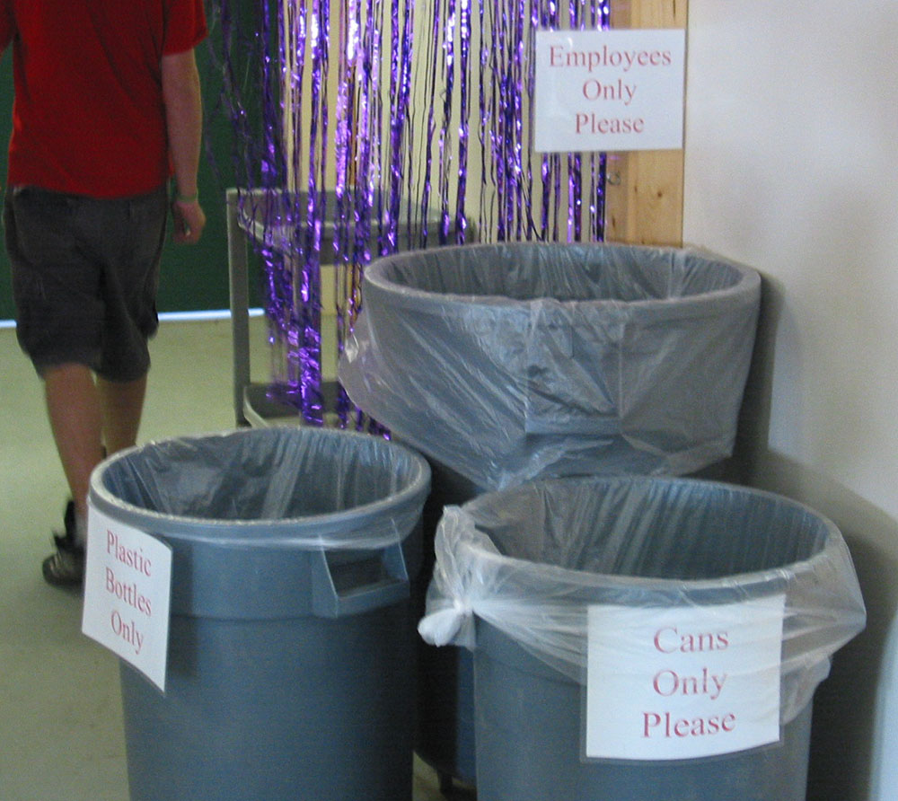 Signs on refuse cans read 'Cans Only', 'Plastic Only', and 'Employees Only'.