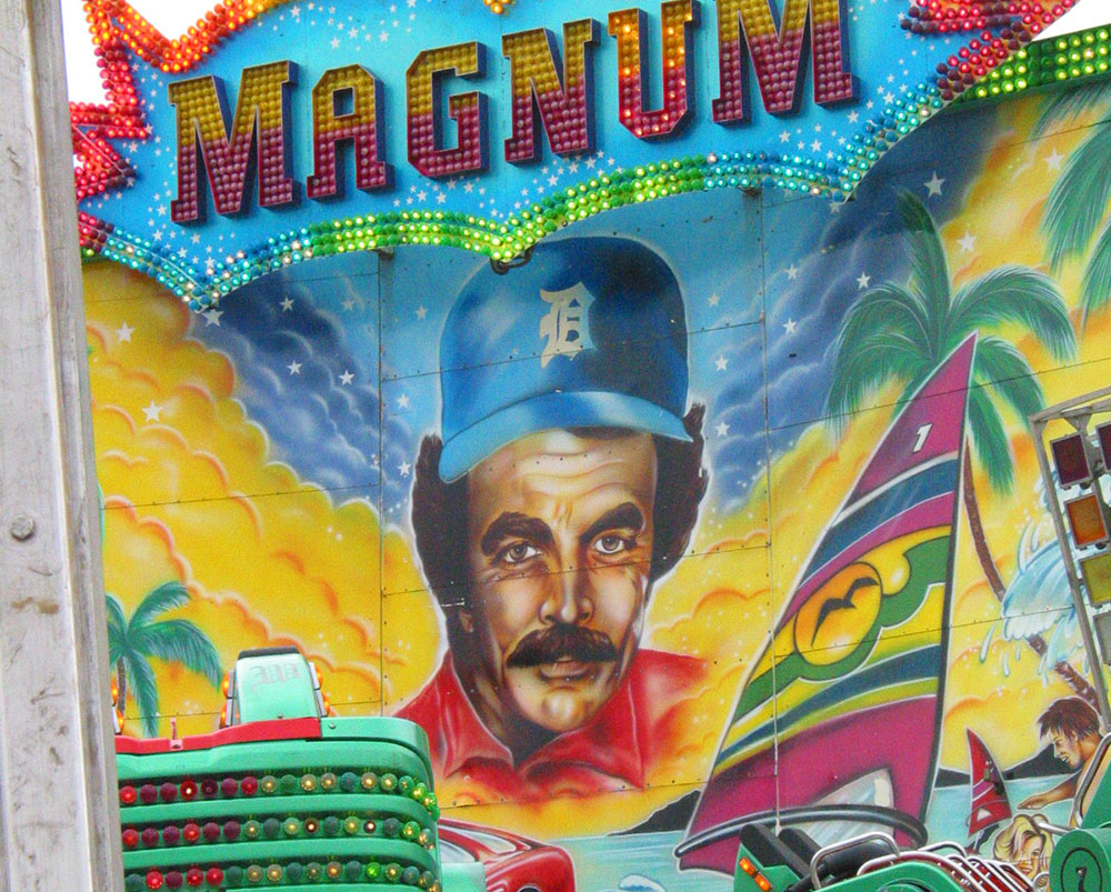 Photo of a likeness of actor Tom Selleck painted on a carnival ride